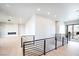 Upstairs hallway leading to a modern living room with a fireplace at 3690 S Spring Mountain Blvd, Pahrump, NV 89048