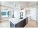 Stylish kitchen featuring a large island with a sink, stainless steel appliances, and hardwood flooring at 3690 S Spring Mountain Blvd, Pahrump, NV 89048