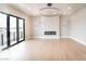 Open living room with modern fireplace, sleek lighting, and balcony access at 3690 S Spring Mountain Blvd, Pahrump, NV 89048