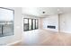 Bright living room with fireplace, modern lighting, and large windows with mountain views at 3690 S Spring Mountain Blvd, Pahrump, NV 89048
