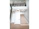Bright staircase with wood stairs, modern railing, and contemporary lighting fixtures at 3690 S Spring Mountain Blvd, Pahrump, NV 89048