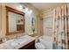 Well-lit bathroom with a tub-shower combo, granite countertop, and vanity with mirror at 2035 E Warm Springs Rd # 1019, Las Vegas, NV 89119