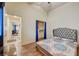 Cozy bedroom featuring a large bed and walk-in closet with blue curtains at 2035 E Warm Springs Rd # 1019, Las Vegas, NV 89119