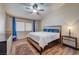 Comfortable bedroom with wood-look floors, ceiling fan, and natural light at 2035 E Warm Springs Rd # 1019, Las Vegas, NV 89119