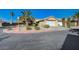 Charming single-story home featuring a two-car garage, desert landscaping, and inviting curb appeal at 2035 E Warm Springs Rd # 1019, Las Vegas, NV 89119