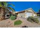Charming single-story home with a two-car garage and desert landscaping under a blue sky at 2035 E Warm Springs Rd # 1019, Las Vegas, NV 89119