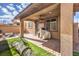 Covered patio with artificial turf and grill at 398 Espressivo St, Henderson, NV 89011