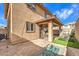 Backyard with covered patio, artificial turf, and fire pit at 398 Espressivo St, Henderson, NV 89011