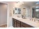 Elegant bathroom boasts double vanity and a large mirror at 398 Espressivo St, Henderson, NV 89011