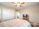 Comfortable bedroom with ceiling fan and built-in TV stand at 398 Espressivo St, Henderson, NV 89011