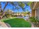 Expansive backyard with lush lawn and a sparkling pool at 525 Summer Mesa Dr, Las Vegas, NV 89144