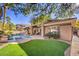 Artificial turf backyard with inviting pool and spa at 525 Summer Mesa Dr, Las Vegas, NV 89144