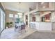 Modern dining area with glass table and kitchen access at 525 Summer Mesa Dr, Las Vegas, NV 89144