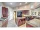 Gourmet kitchen boasts granite counters and dark wood cabinets at 525 Summer Mesa Dr, Las Vegas, NV 89144