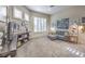Comfortable living room with built-in shelving, a cozy couch and large windows for natural light at 525 Summer Mesa Dr, Las Vegas, NV 89144