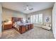 Main bedroom with large bed, plenty of natural light and relaxing chair at 525 Summer Mesa Dr, Las Vegas, NV 89144