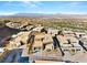 Wide aerial showcasing a community of modern homes amidst a desert landscape and mountain views at 612 Dragon Mountain Ct, Henderson, NV 89012