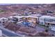 Aerial view showcasing modern homes with pools, stunning desert landscape, and mountainous backdrop at 612 Dragon Mountain Ct, Henderson, NV 89012
