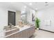 Modern bathroom featuring double sink vanity, a large mirror, and stylish light fixtures at 612 Dragon Mountain Ct, Henderson, NV 89012