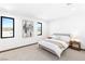 Bright bedroom featuring neutral tones, carpet flooring, and large windows showcasing the scenic views at 612 Dragon Mountain Ct, Henderson, NV 89012