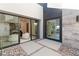 Modern courtyard with glass sliding doors, stone pavers, and sleek design at 612 Dragon Mountain Ct, Henderson, NV 89012