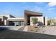 Modern home showcasing a unique angular design, stone accents, and a spacious three-car garage at 612 Dragon Mountain Ct, Henderson, NV 89012