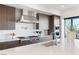Contemporary kitchen with stainless steel hood, island and breakfast bar at 612 Dragon Mountain Ct, Henderson, NV 89012