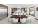 Contemporary kitchen with stainless steel appliances, an island with seating, and a dining area at 612 Dragon Mountain Ct, Henderson, NV 89012