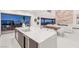 Modern kitchen with large island, white countertops, and seamless flow to outdoor dining at 612 Dragon Mountain Ct, Henderson, NV 89012