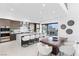 Bright, open kitchen featuring an island with seating, modern appliances, and seamless indoor-outdoor dining at 612 Dragon Mountain Ct, Henderson, NV 89012