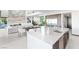 Open concept kitchen with large island, dining area, and sleek white interior at 612 Dragon Mountain Ct, Henderson, NV 89012
