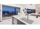 Modern kitchen with island, bar sink and seating, and outdoor views at 612 Dragon Mountain Ct, Henderson, NV 89012