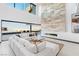 Bright, open living space with stone accent wall, modern fireplace, and expansive sliding doors with outdoor views at 612 Dragon Mountain Ct, Henderson, NV 89012