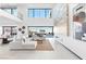 Bright living room boasting high ceilings, a stone accent wall, and expansive glass doors with great views at 612 Dragon Mountain Ct, Henderson, NV 89012