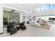 Open-concept living room with a wine cellar, neutral furniture, and access to an outdoor space at 612 Dragon Mountain Ct, Henderson, NV 89012