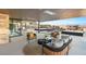Covered outdoor patio with comfortable seating, heaters, and views of the surrounding landscape at 612 Dragon Mountain Ct, Henderson, NV 89012