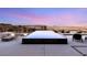 Relaxing poolside view with a fire pit and comfortable seating amidst a scenic backdrop and dusk skyline at 612 Dragon Mountain Ct, Henderson, NV 89012
