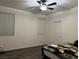 Bright bedroom with ceiling fan and wood-look flooring at 5591 La Perla Ct, Las Vegas, NV 89122