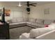 Spacious living room with large sectional sofa and ceiling fan at 5591 La Perla Ct, Las Vegas, NV 89122