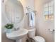 Bathroom featuring a modern sink, round mirror, and towel rack next to a window at 10332 Perfect Parsley St, Las Vegas, NV 89183