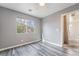 This bedroom features wood floors and a window looking out to the yard at 10332 Perfect Parsley St, Las Vegas, NV 89183