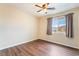 This bedroom features neutral walls, wood floors, a window, and ceiling fan at 10332 Perfect Parsley St, Las Vegas, NV 89183