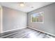 This bedroom features wood floors, a window letting in natural light, and a ceiling fan at 10332 Perfect Parsley St, Las Vegas, NV 89183