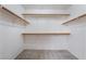 Spacious walk-in closet with multiple levels of shelving and hanging rods at 10332 Perfect Parsley St, Las Vegas, NV 89183