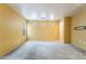 View of a large living room with carpet flooring, neutral walls, and natural light at 10332 Perfect Parsley St, Las Vegas, NV 89183