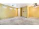 View of a large living room with carpet flooring, neutral walls, and natural light at 10332 Perfect Parsley St, Las Vegas, NV 89183