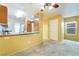 View of an eat-in kitchen and doorway with carpet flooring and light yellow walls at 10332 Perfect Parsley St, Las Vegas, NV 89183