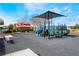 Community playground with slides and picnic area surrounded by lush landscaping at 10332 Perfect Parsley St, Las Vegas, NV 89183