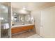 Bright bathroom featuring double sinks, granite counters, and tiled floors at 211 E Flamingo Rd # 610, Las Vegas, NV 89169