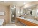 Bright bathroom featuring double sinks, granite counters, and glass shower at 211 E Flamingo Rd # 610, Las Vegas, NV 89169